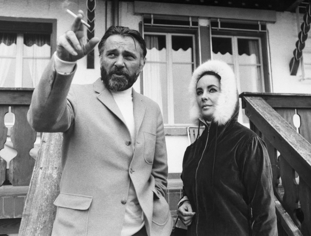 Elizabeth Taylor and Richard Burton outside of their Gstaad chalet in 1966