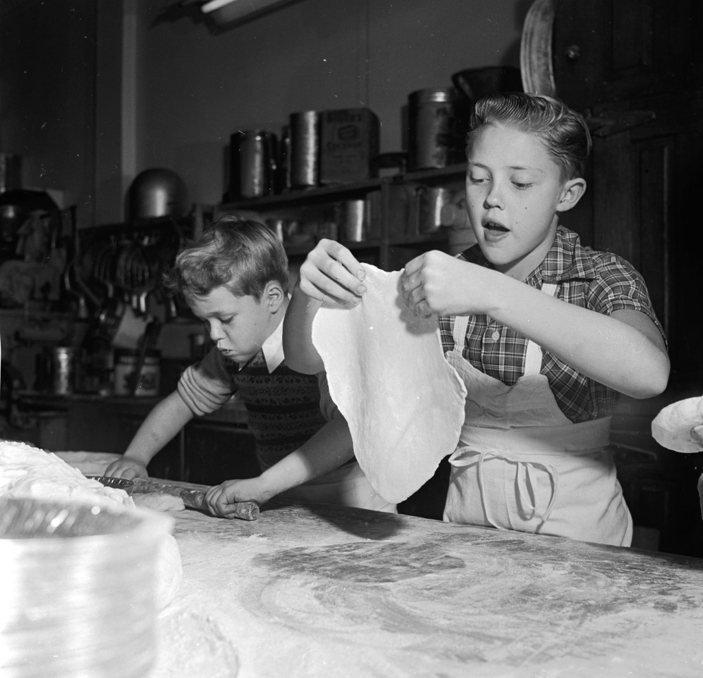 Young television stars Glenn (left) and Ronnie Walken, later film star Christopher Walken, roll out dough for pie crusts at their father's bakery.
