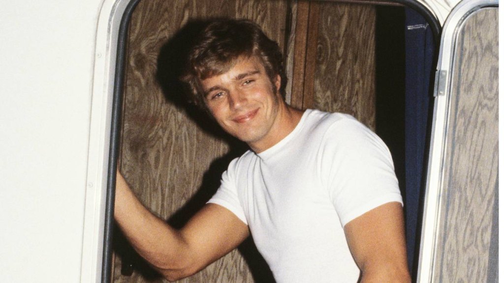 young man in trailer smiling