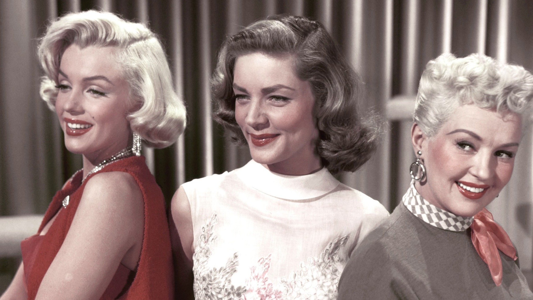 Marilyn Monroe, Lauren Bacall and Betty Grable pose for a portrait on the set of 'How to Marry a Millionaire'