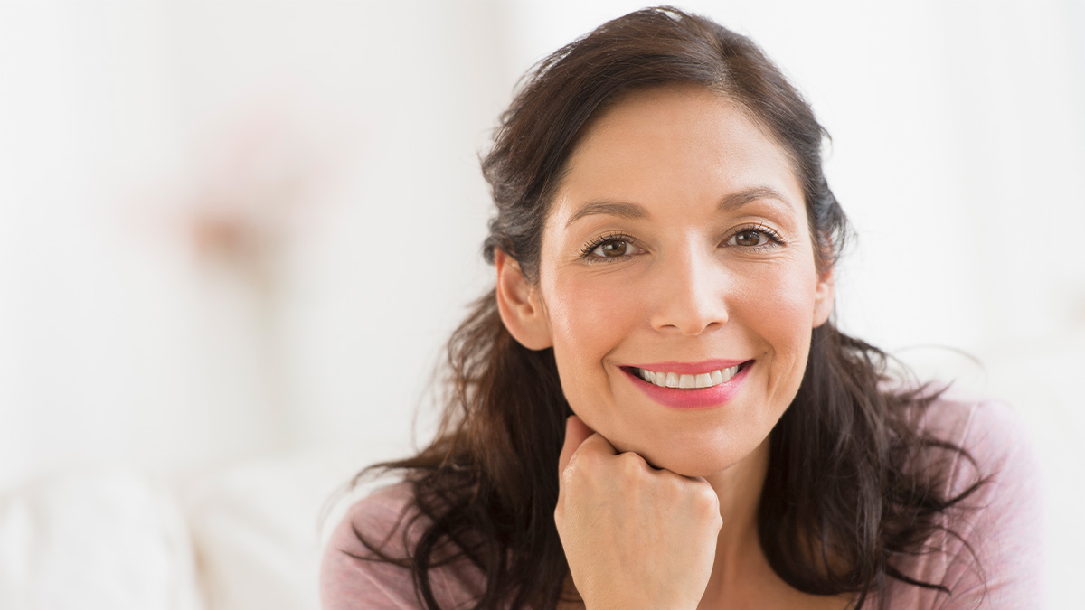 Woman with thick beautiful hair after learning about the scalp serum benefits