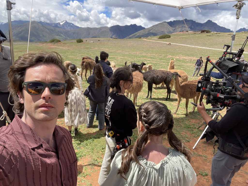 Alec Santos hangs out with alpacas during the filming of A Machu Picchu Proposal