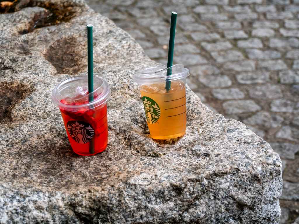 Two drinks from Starbucks which have been abandoned on a stone bench in Central London.