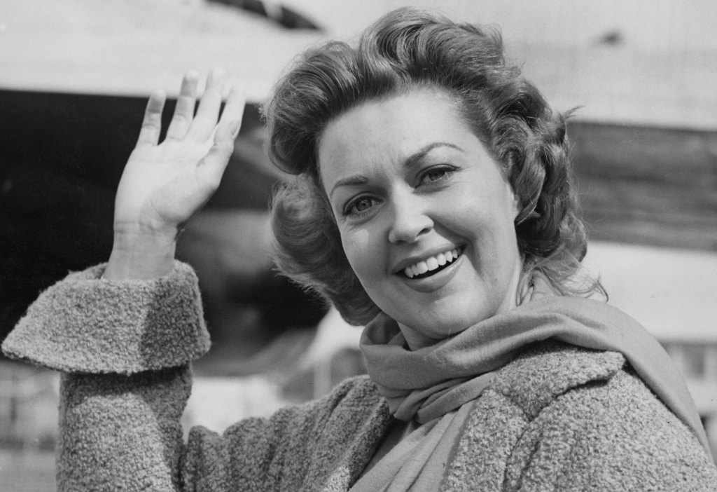 Joan Shawlee (arrives at London Airport to appear on British television, 1954. 