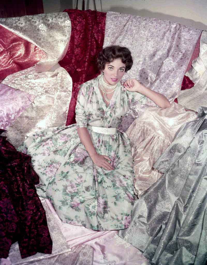 Joan Collins surrounded by silks in the '50s