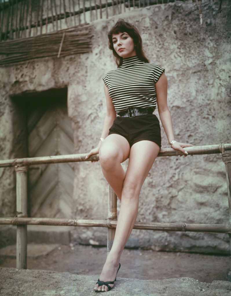 Joan Collins in a striped shirt and shorts in the '50s