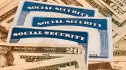 Social Security cards surrounded by money