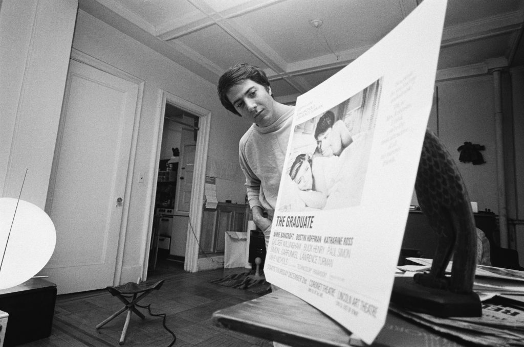 Dustin Hoffman looks at a ad for The Graduate which was banned from the New York City subways for being in poor taste