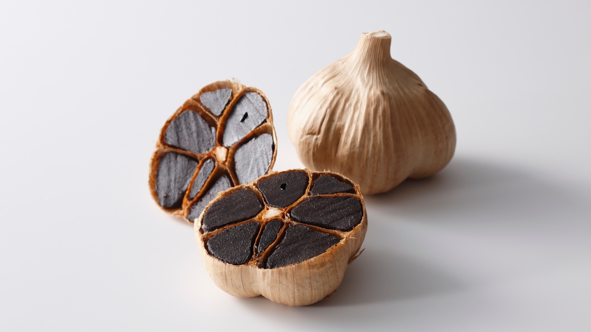 Black garlic gloves on a white background