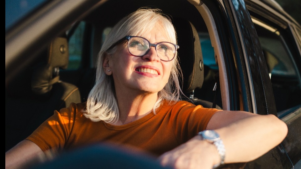 A senior driving a car