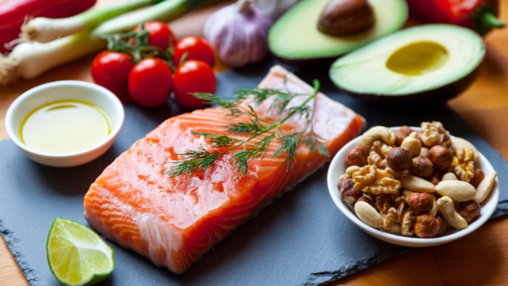 Table top still life of foods high in healthy fats such as salmon, olive oil, nuts and avocados with vegetables and herbs to support a healthy gut microbiome and prevent Alzheimer's