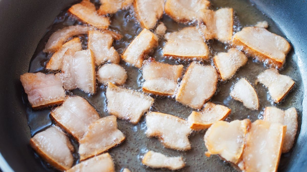 Beef fat melting in a pot on the stove to make beef tallow