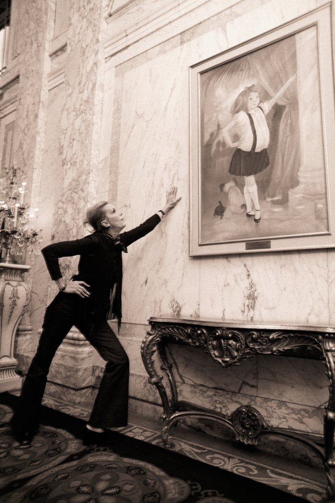 Kay Thompson poses with a portrait of Eloise at the Plaza Hotel in 1969