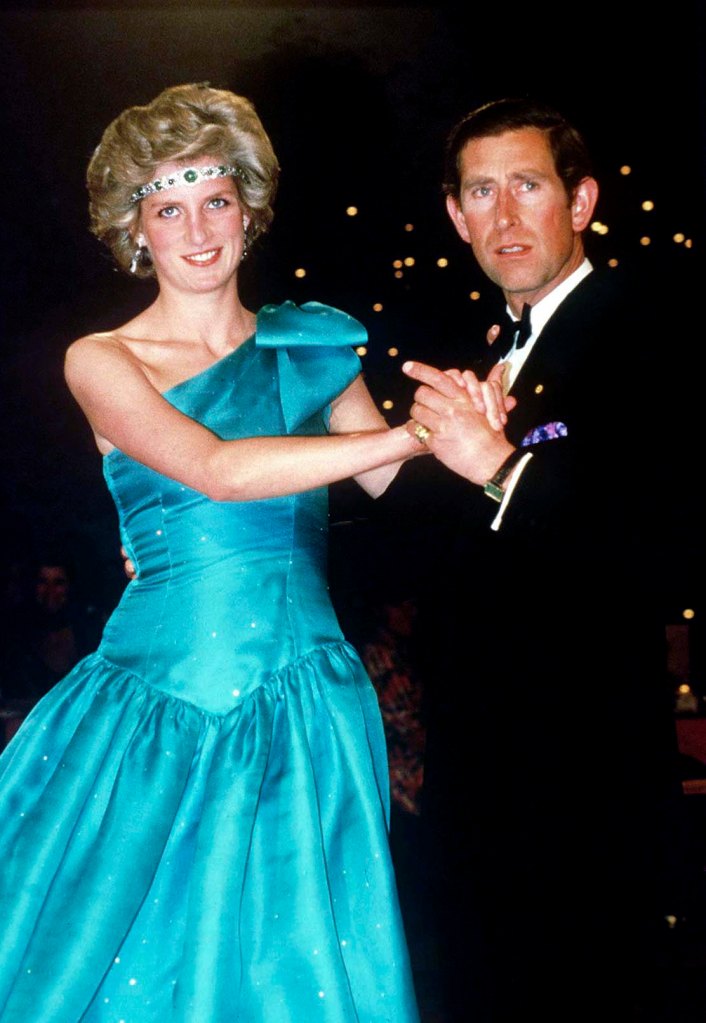 Princess Diana wears an emerald choker as a headband while dancing with Prince Charles in 1985