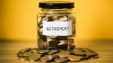 A lot coins in glass money jar with yellow background. Saving for Retirement concept.