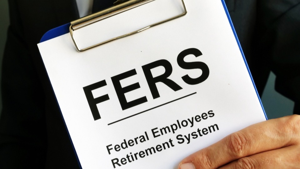A clipboard showing Federal Employees Retirement System paper