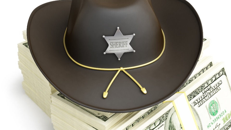 A sheriff hat on money