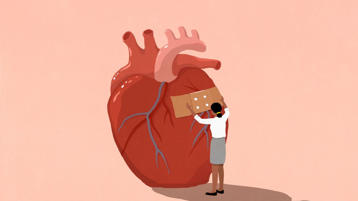 Woman putting bandage over heart on pink background