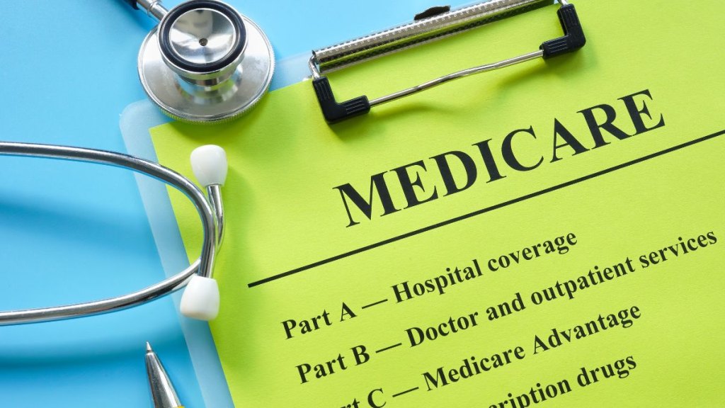 Papers about types of medicare insurance and a stethoscope.