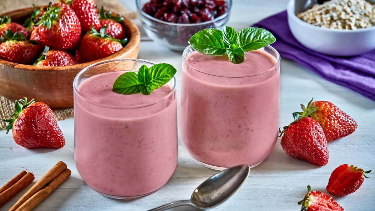 Minimally-processed strawberry smoothies on a wooden table