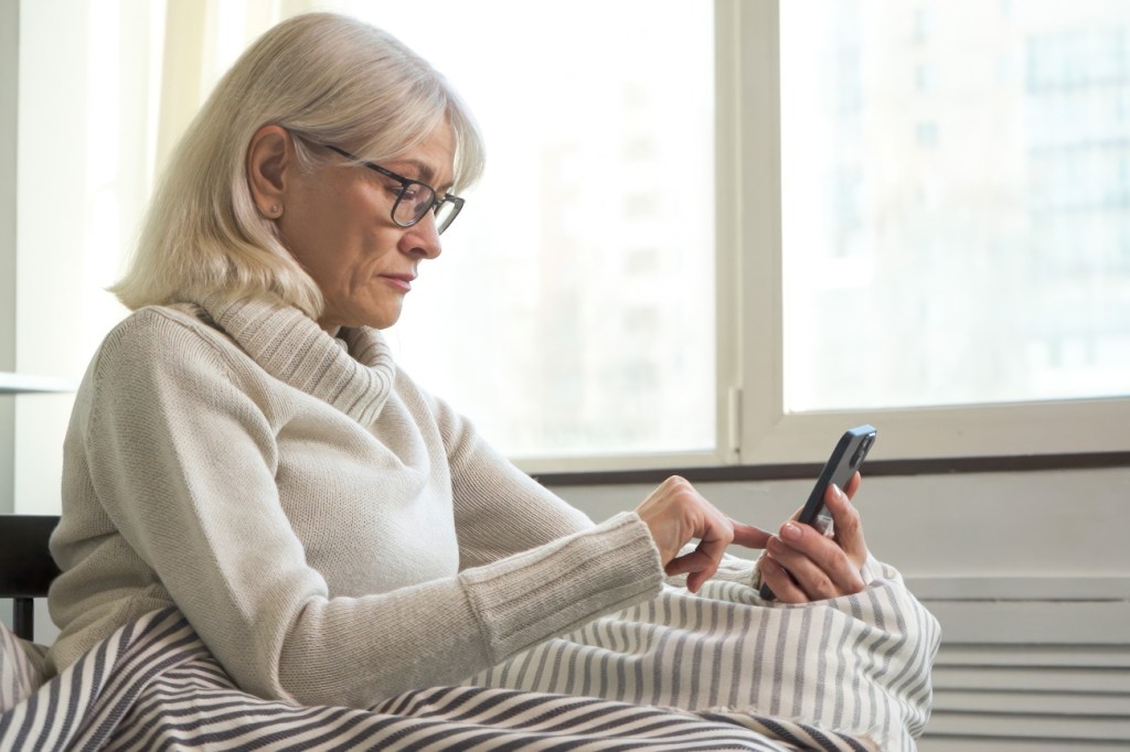 A senior woman looking at her phone