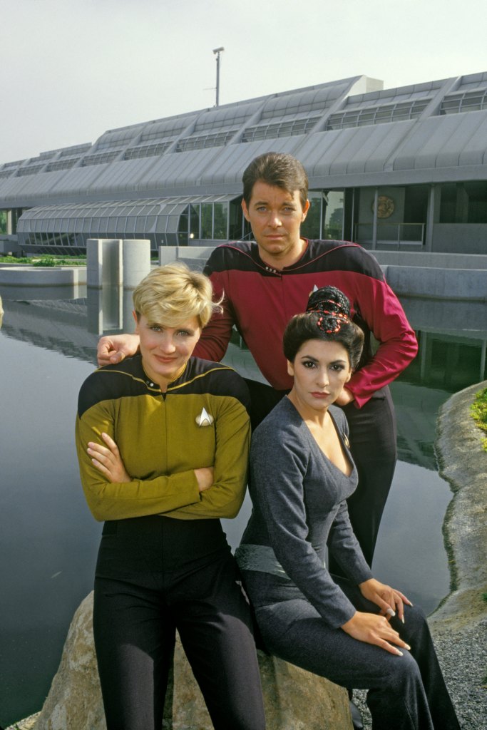NORTH HOLLYWOOD, CA - 1987: Jonathan Frakes (rear), Denise Crosby (left) and Marina Sirtis, stars of TV's Star Trek-The Next Generation, pose for a group photo during a 1987 North Hollywood, California, portrait session.