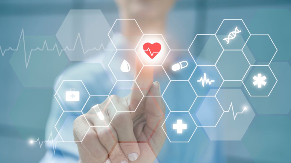 Businesswoman touching heart shape on digital display