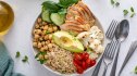 A bowl of lean chicken, chickpeas, quinoa, cauliflower, cherry tomatoes and avocado, which are part of a low-cholesterol diet