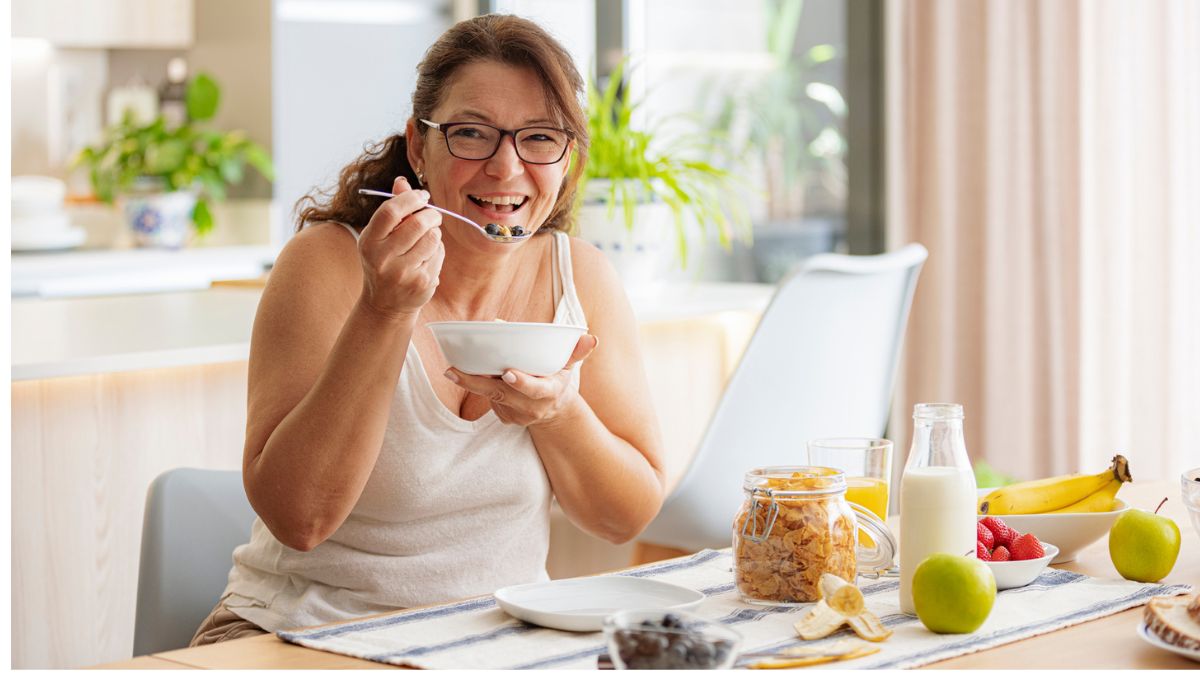 Smiling woman eating healthy foods as part of a prediabetes diet