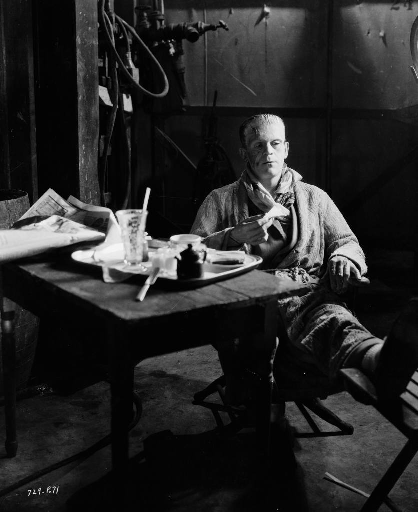 circa 1935: Still wearing the monster make-up for his role in 'Bride of Frankenstein', directed by James Whale, English actor Boris Karloff (1887 - 1969) sits down for a snack on set