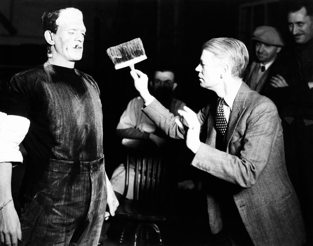 THE BRIDE OF FRANKENSTEIN, first three from left: Boris Karloff, makeup artist Jack Pierce, director James Whale, on set, 1935