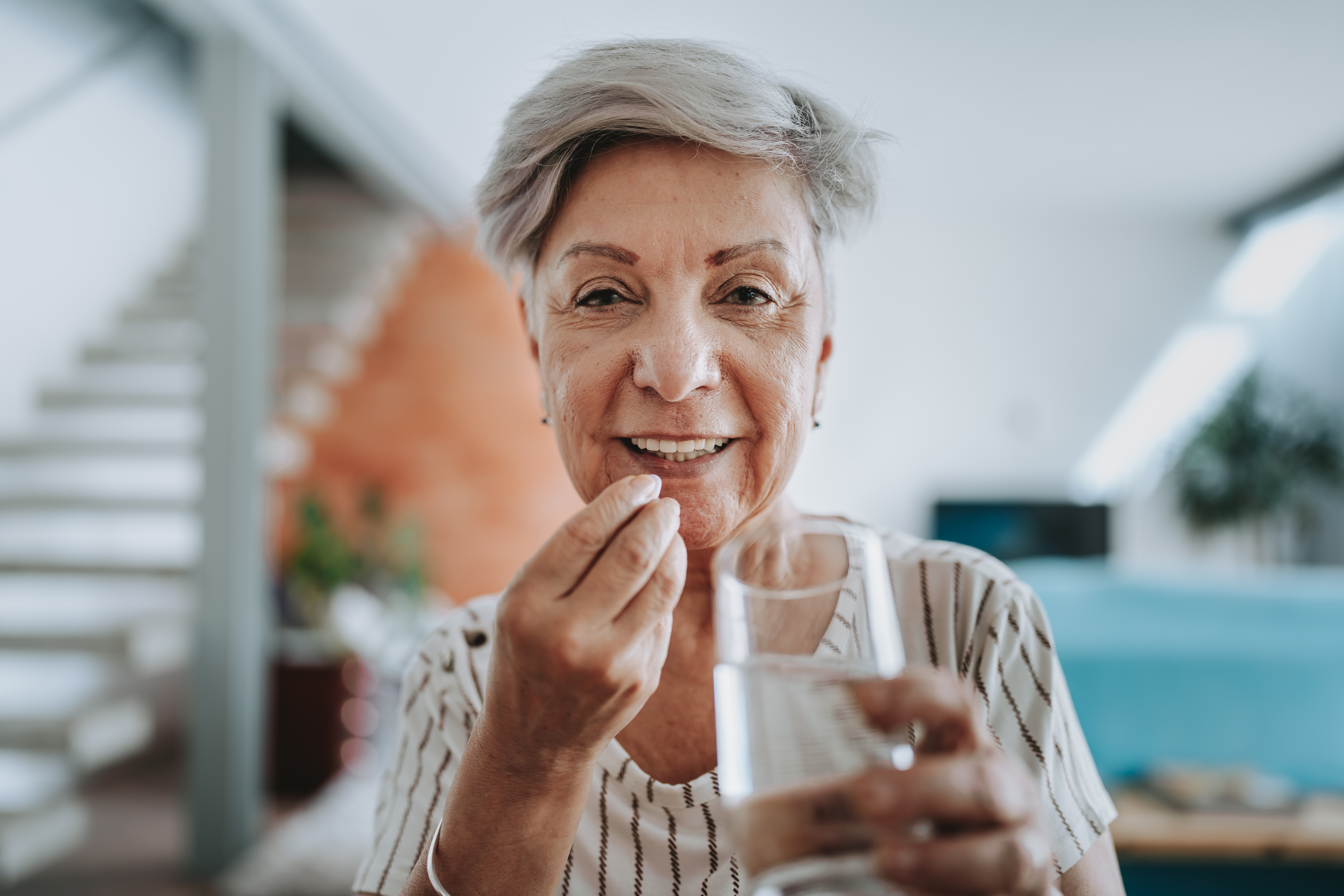 Woman taking vitamins and supplements.