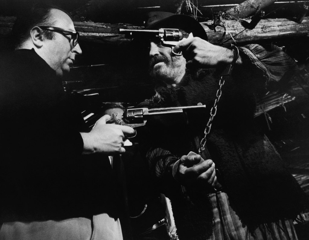 Sergio Leone and Jason Robards with guns on set of Once Upon a Time in the West