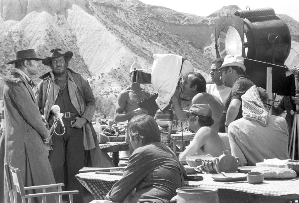 Italian director Sergio Leone directing American actors Henry Fonda and Jason Robards on the set of the film Once Upon a Time in the West