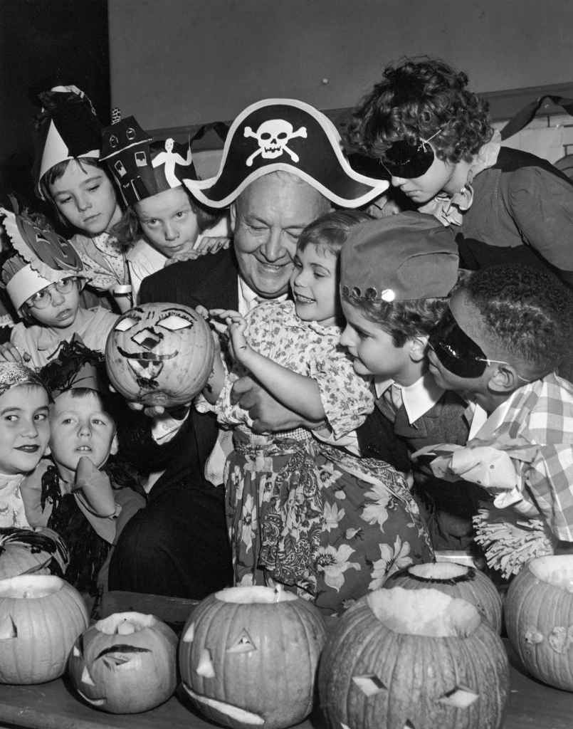A group of children celebrate Halloween with opera singer Lauritz Melchior in 1955