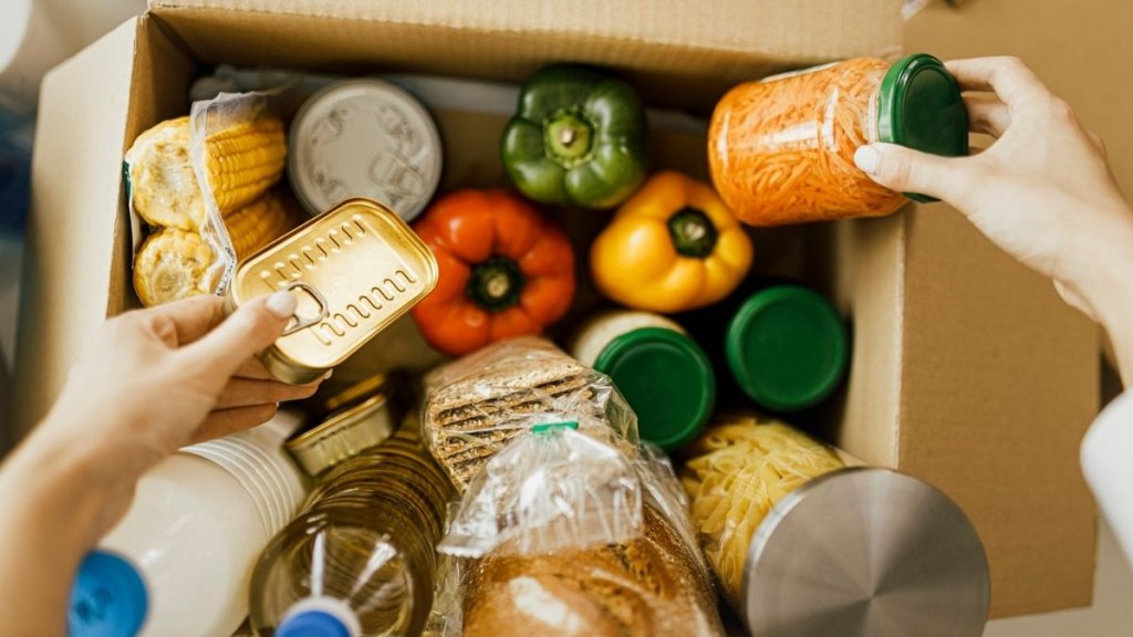 Details of Volunteer with box of food for poor