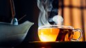 Picture of glass of tea for heartburn next to a tea cup