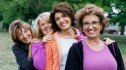 A group of smiling women with different types of diabetes embrace