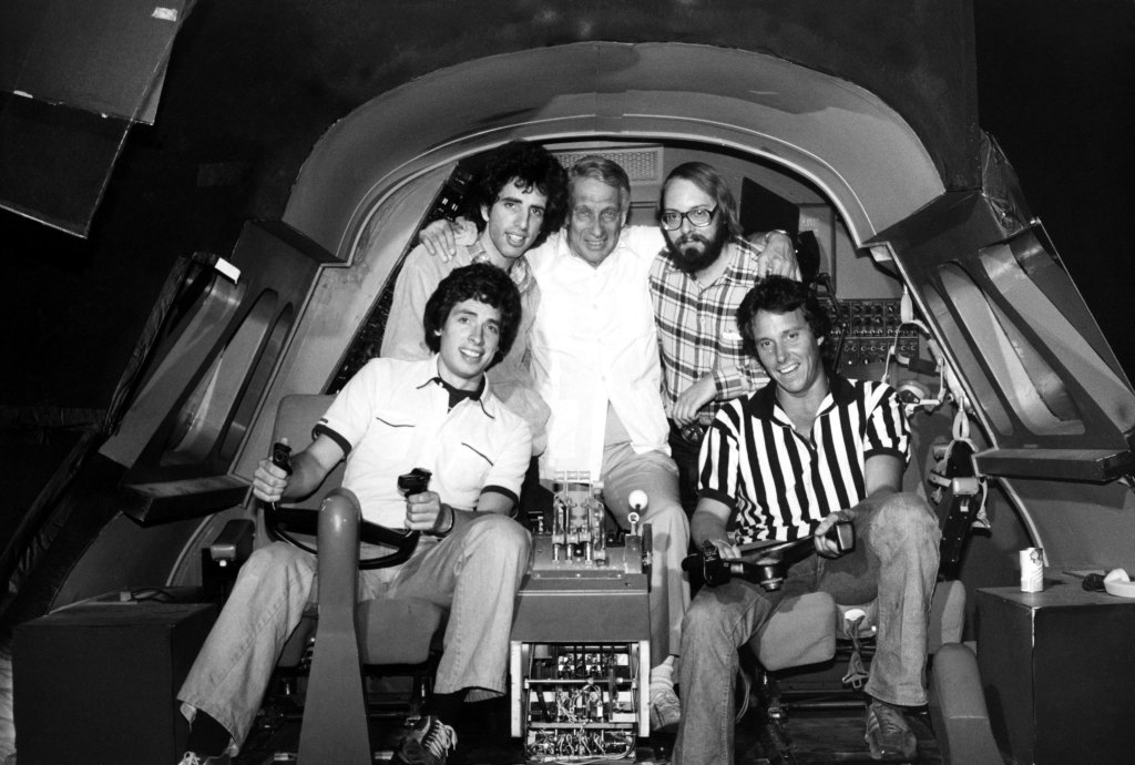Clockwise from bottom left: David Zucker, Jerry Zucker, producers Howard Koch and Robert K. Weiss and Jim Abrahams on the set of Airplane! (1980)
