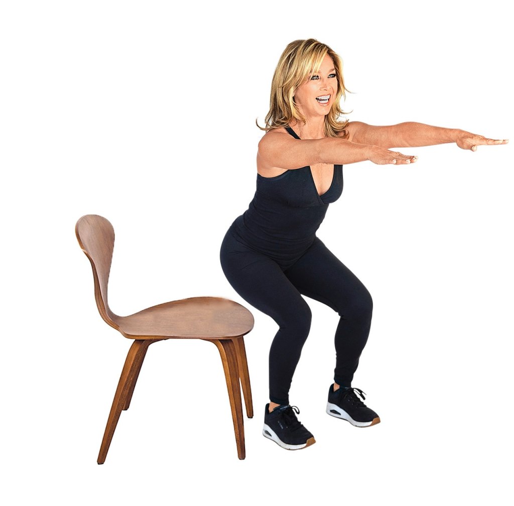 Denise Austin demonstrates a power squat, hovering over a chair.