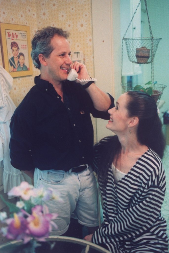 Ex-child actor Keith Thibodeaux (L) w. his wife, dancer Kathy Denton as he talks on phone, at home.