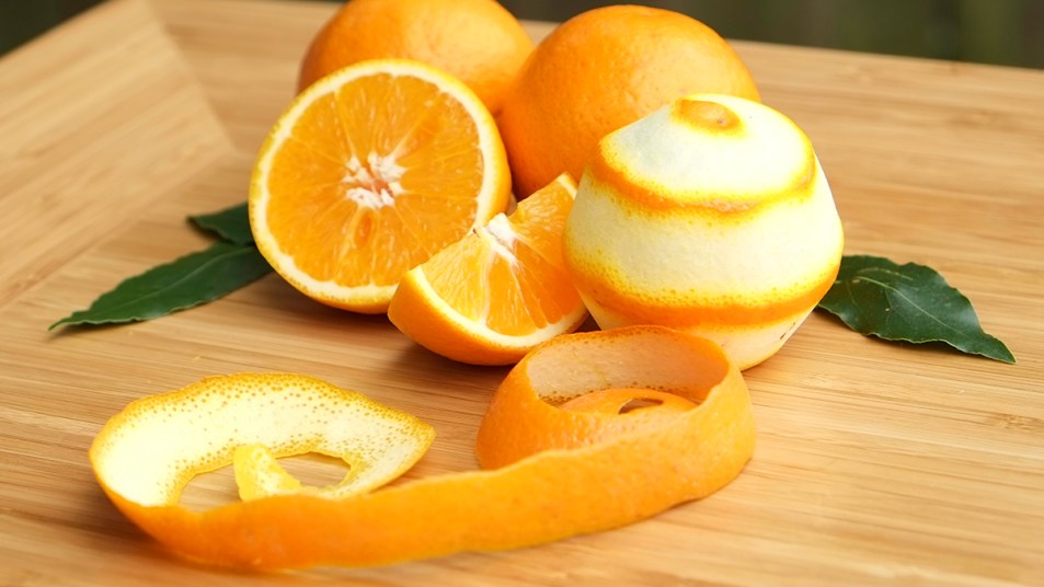 An orange with it's peel lying nearby, which contains hesperidin