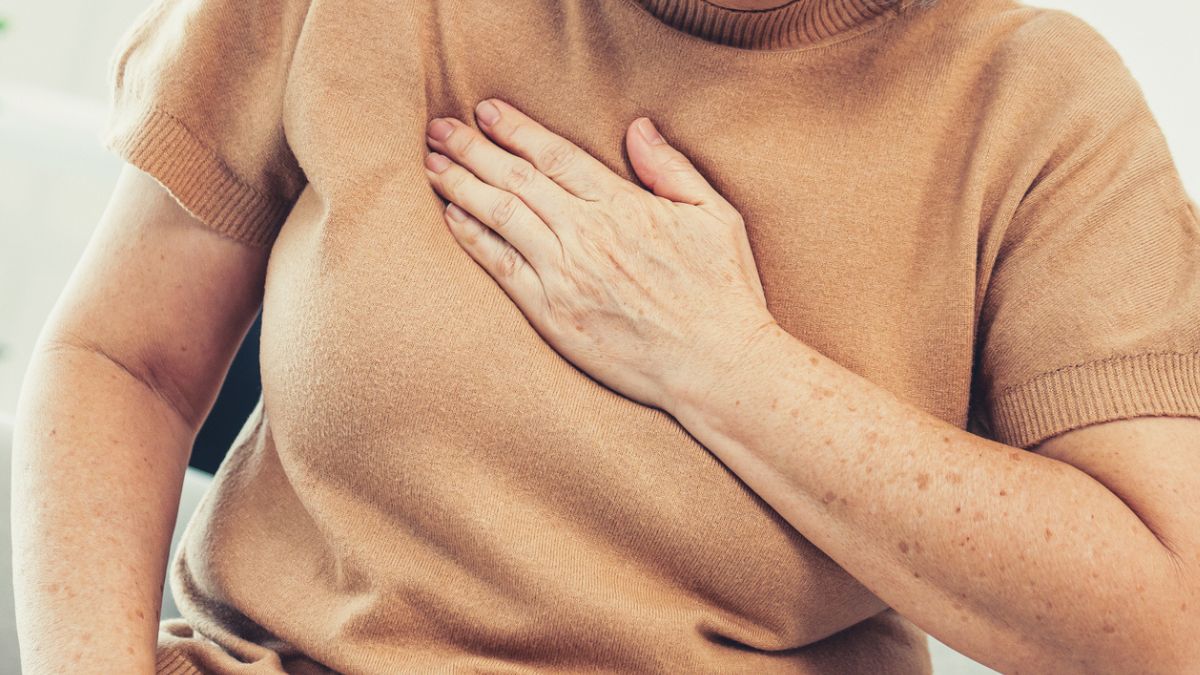 Woman placing hand to heart