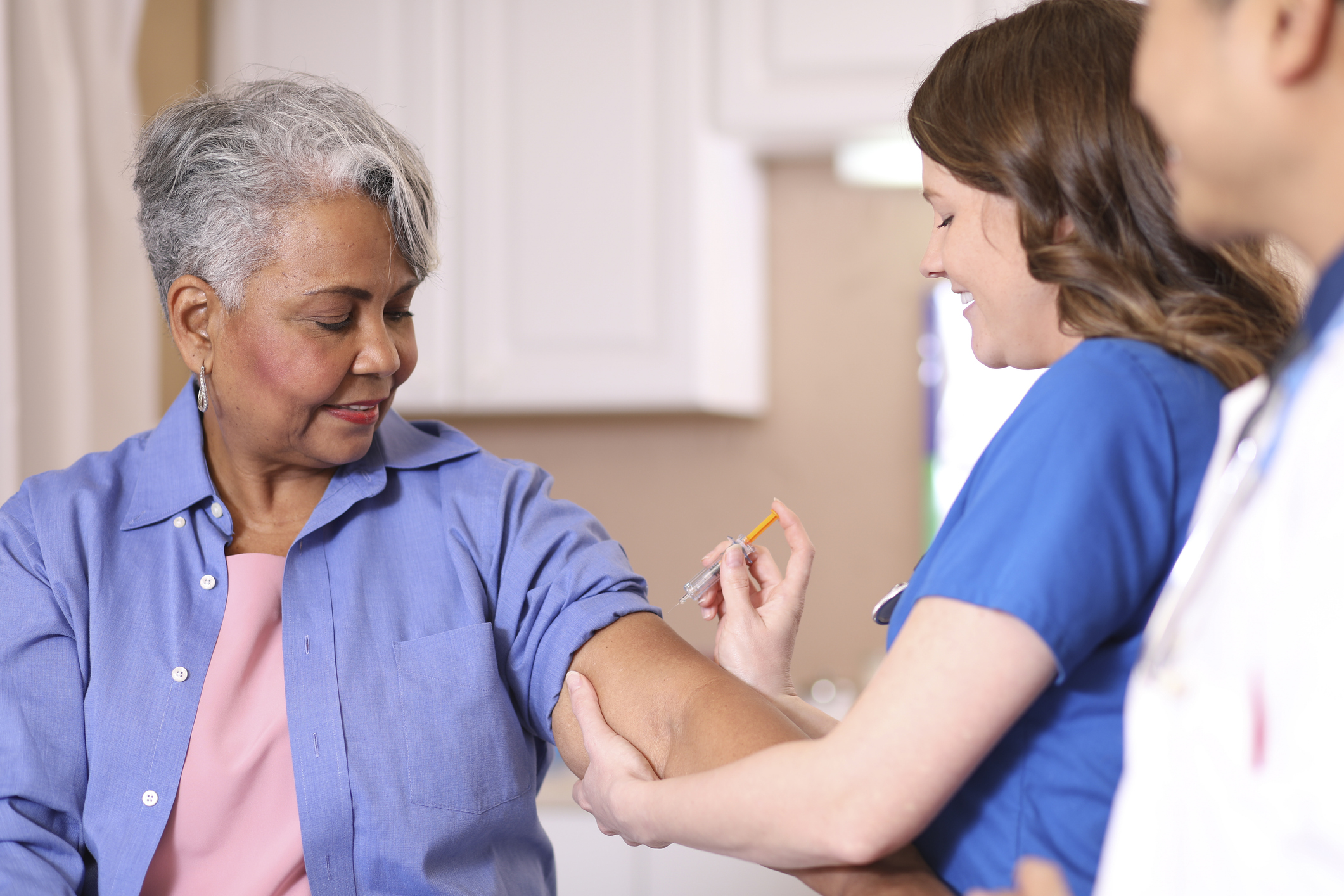 Older woman getting a low-dose COVID vaccine