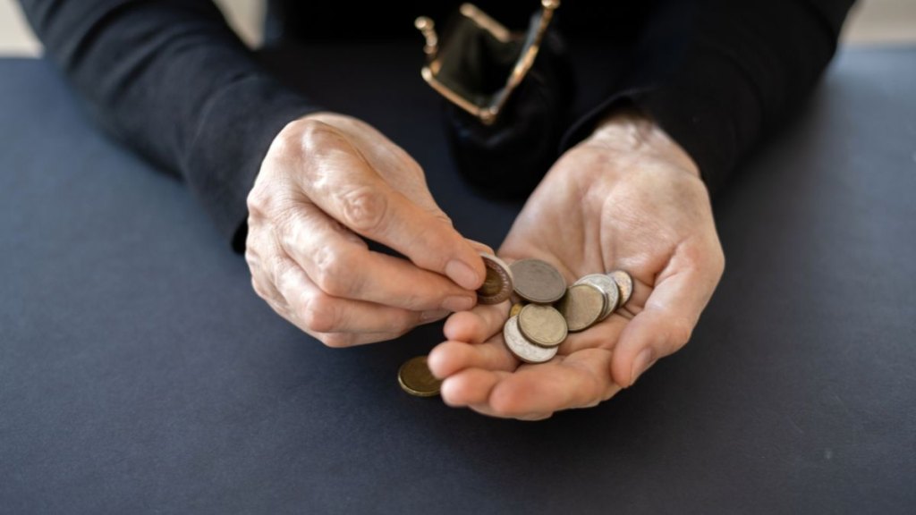 woman paying with coins