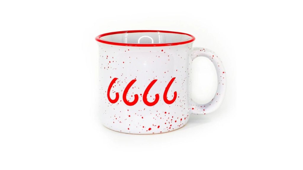 A white red speckled ceramic camp mug