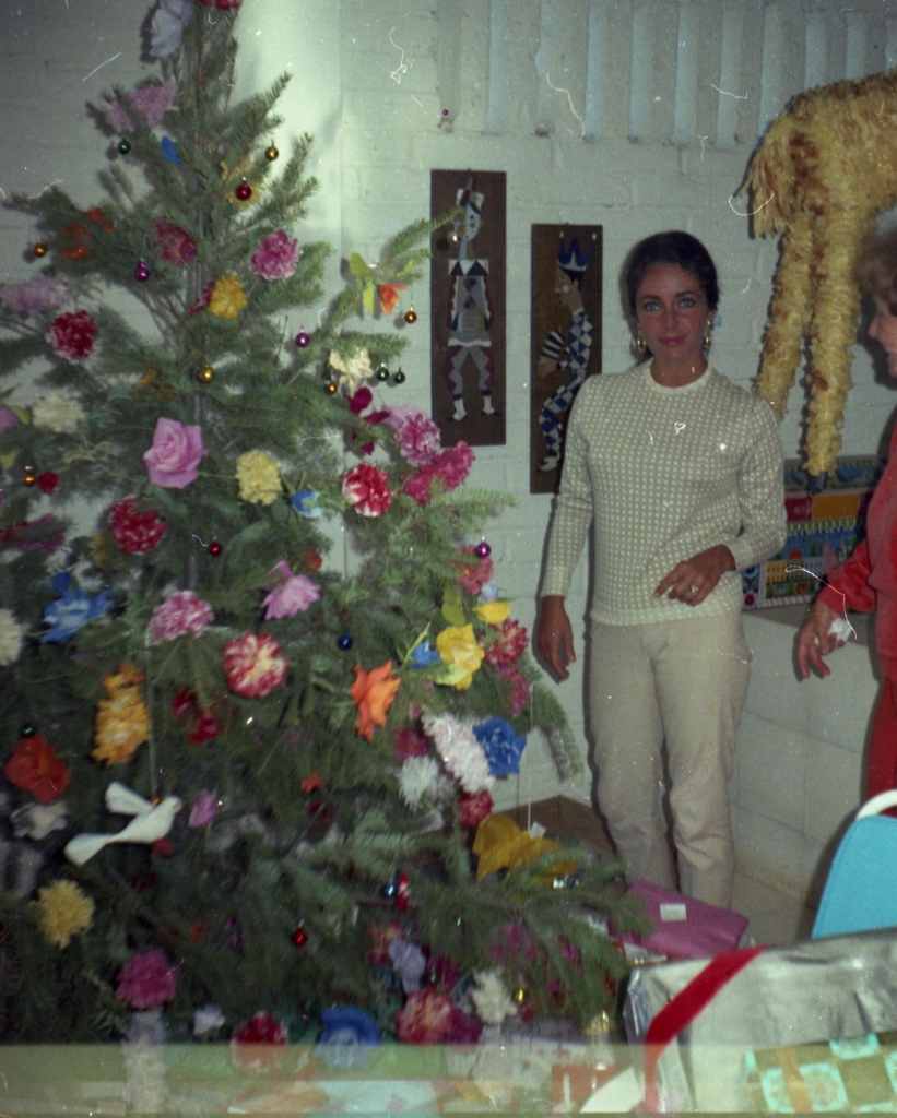Elizabeth Taylor poses with her Christmas tree in a vintage snapshot