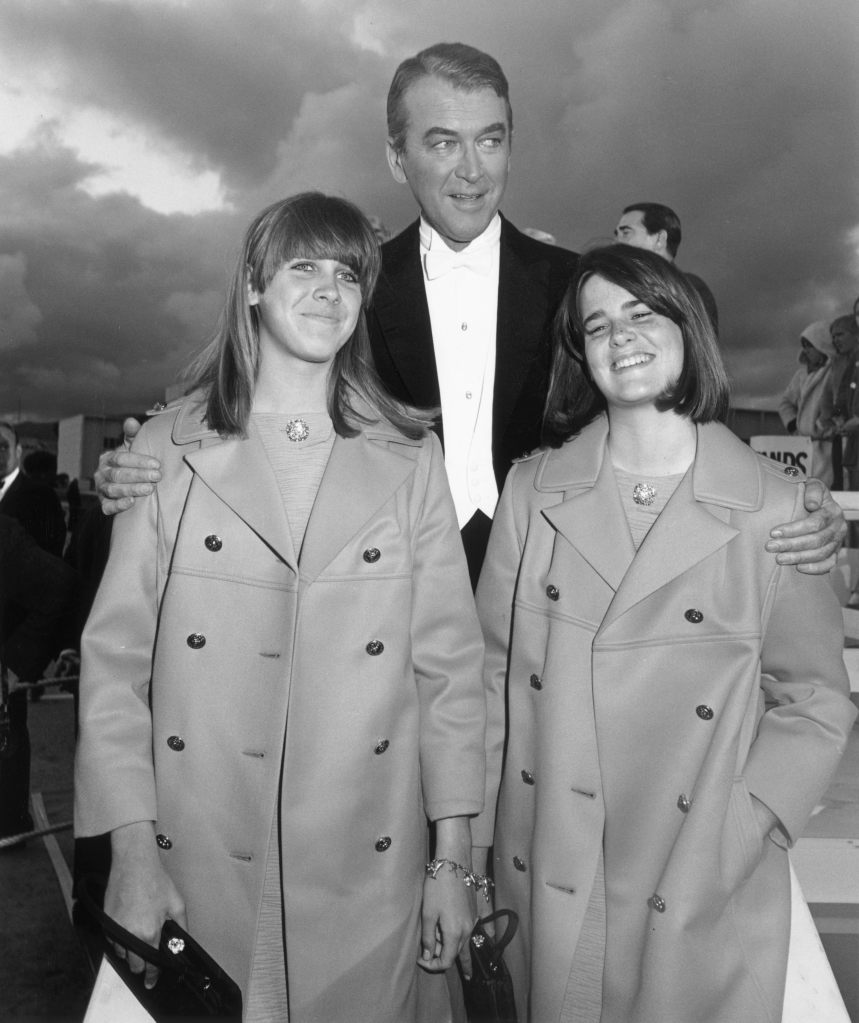 James Stewart with his twin daughters, Judy (L) and Kelly, while arriving at the Academy Awards, Santa Monica, California (1967)