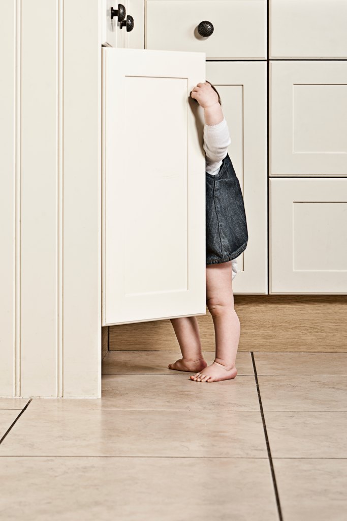 Child looking in cabinet