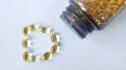 vitamin d capsules in a jar and on a table